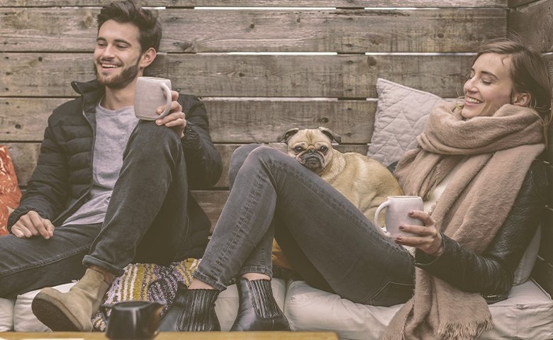 couple with a dog laughing and talking