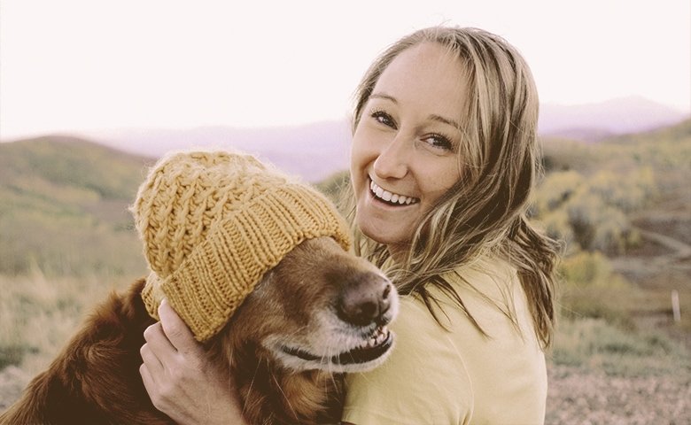 girl covering dog's eyes