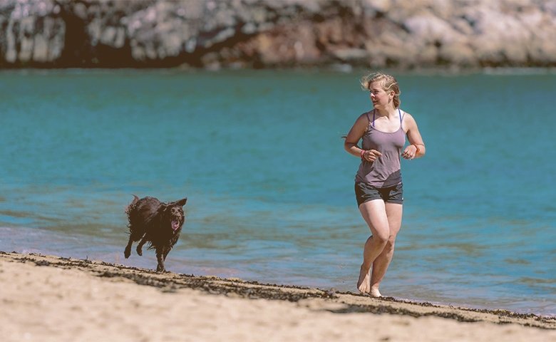 girl running with her dog