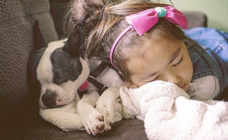 girl sleeping with her dog