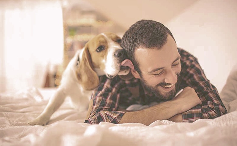 dog licking men face