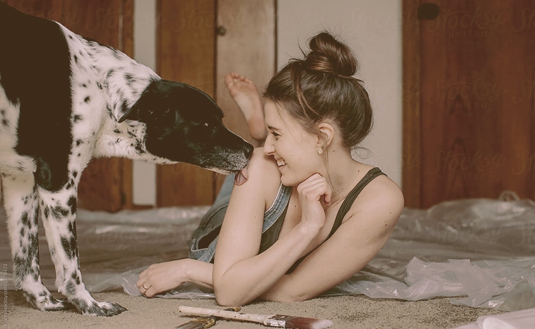 dog licking women shoulder