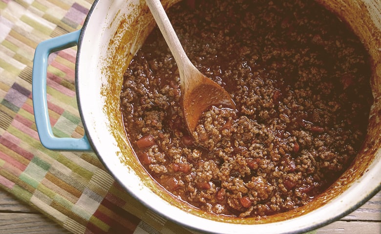 Bowl of chili People foods: Ground meat in pot with chili powder and cayenne pepper