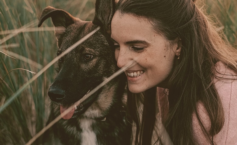 woman embracing her German Shepherd