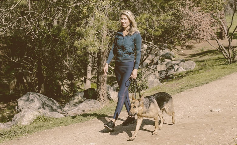 women walking with her German Shepherd dog