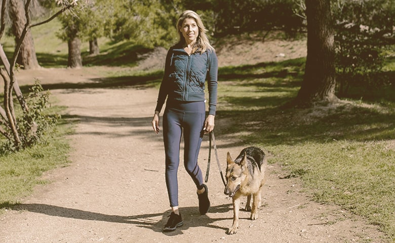 women walking with her German Shepherd dog