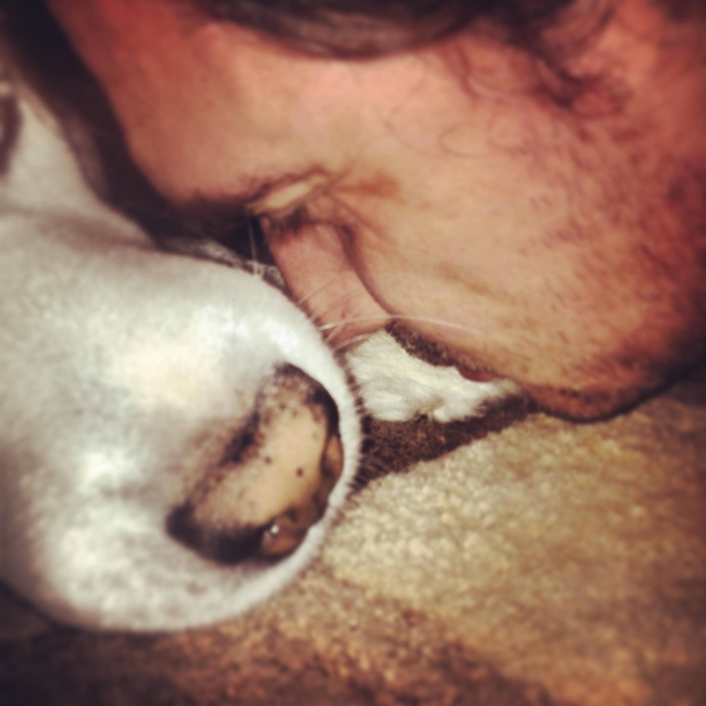 Alex and his white Husky, Sam, rubbing noses